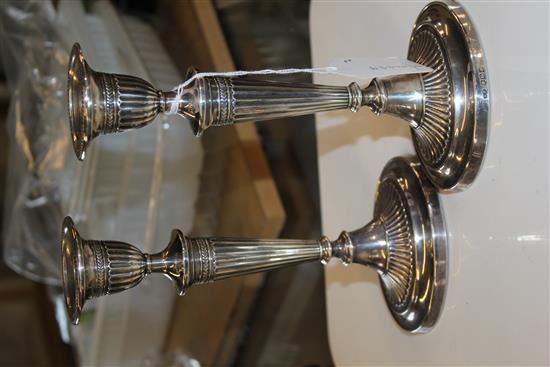 Pair of George V Adam style silver candlesticks of oval fluted form, weighted